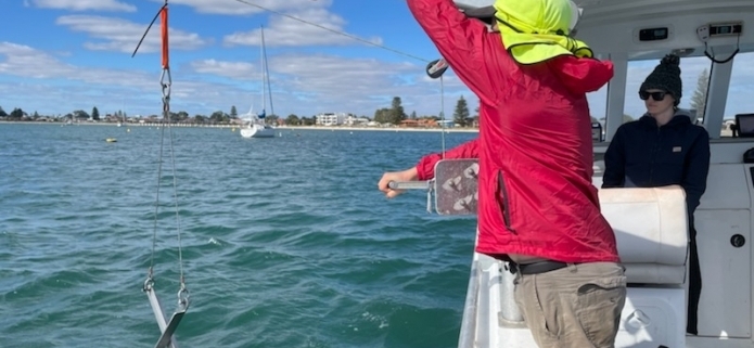 Sediment sampling with a grabber on a boat