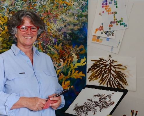 Artist Angela Rossen, who is a judge of From Waste to Wonder, in front of her 8 metre long painting of Elizabeth Reef. Photo: Supplied Angela Rossen