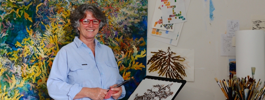 Artist Angela Rossen, who is a judge of From Waste to Wonder, in front of her 8 metre long painting of Elizabeth Reef. Photo: Supplied Angela Rossen