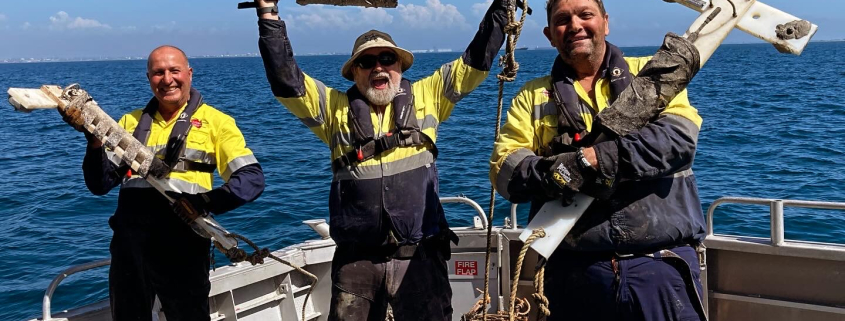 Three men from the Noise theme team hold up recorders they retrieved from Cockburn Sound.