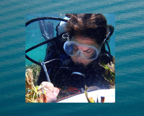 Alicia Sutton at work underwater with notepad (with background image)